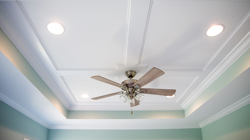 Energy-efficient ceiling fan installation with LED lights in a contemporary room for improved cooling